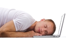 image of man sleeping at his laptop